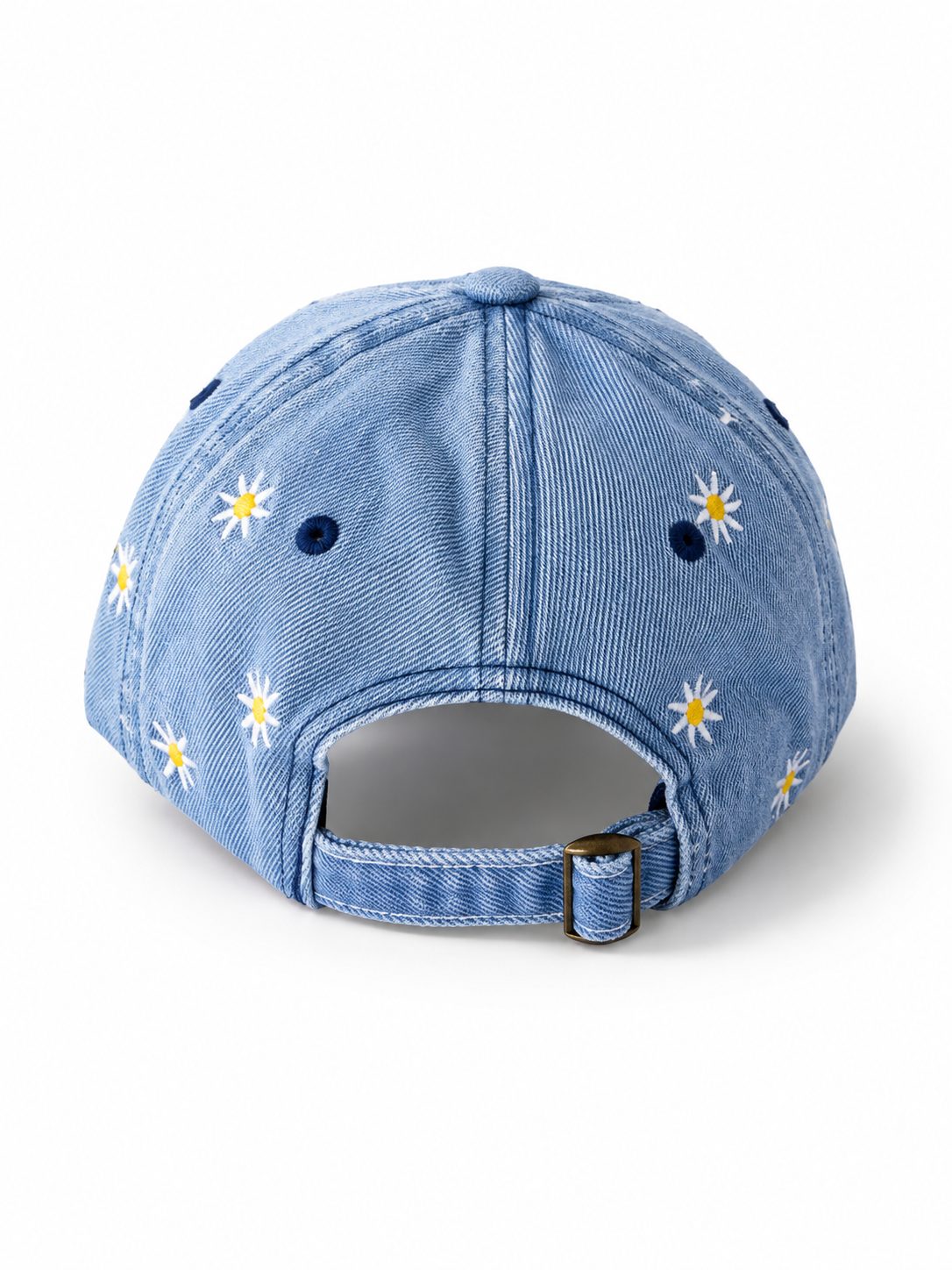 Mid-wash denim baseball cap embroidered with white and yellow daisies, front view on a white background.