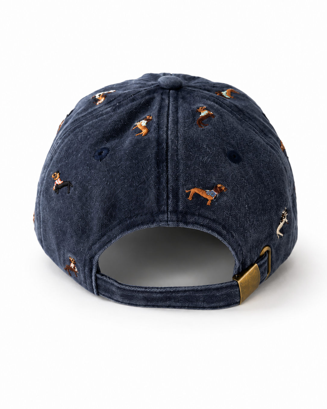 Back view of the navy dachshund-embroidered cap, showing the curved crown and the adjustable strap clipped into its brass buckle.