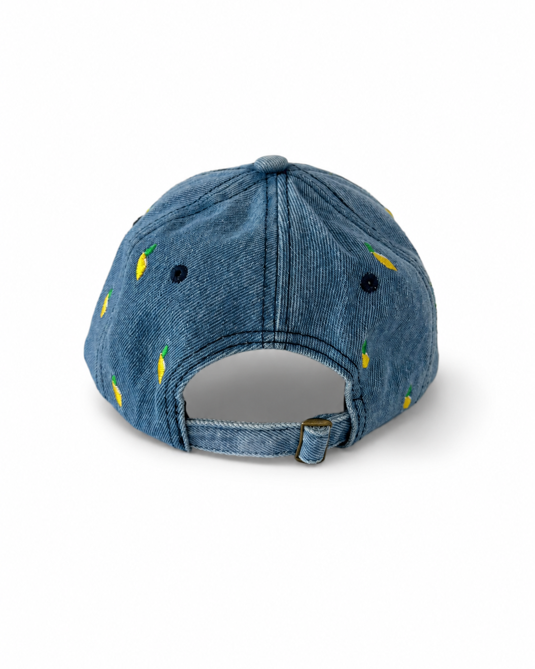 Back view of the mid-wash lemon-embroidered cap, showing the curved crown and the adjustable strap clipped into its brass buckle.