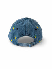 Mid-wash denim baseball cap embroidered with small yellow lemons, front view on a white background.