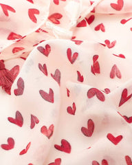 Close-up of red heart print on off-white lightweight scarf