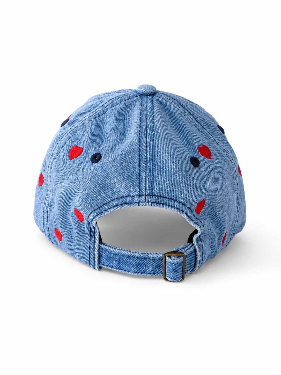 Mid-wash denim baseball cap embroidered with small red hearts, front view on a white background.