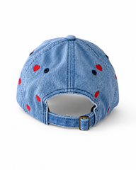 Back view of the mid-wash heart-embroidered cap, showing the curved crown and the adjustable strap clipped into its brass buckle.