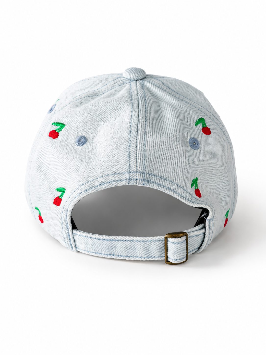 Light-wash denim baseball cap embroidered with small red cherries, front view on a white background.