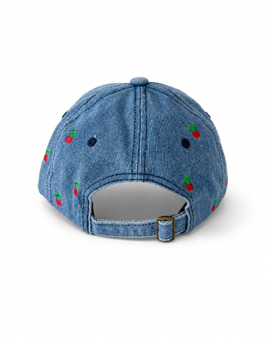 Back view of the mid-wash cherry-embroidered cap, showing the curved crown and the adjustable strap clipped into its brass buckle.