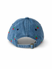 Mid-wash denim baseball cap embroidered with small red cherries, front view on a white background.