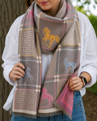 Person wearing a patterned scarf with horse designs in various colors.