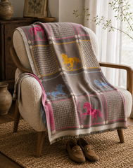 Plaid blanket with horse patterns draped over a chair in a cozy room.