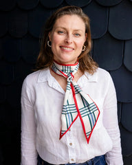 Satin neck scarf and bag tie in red check print styled around the neck