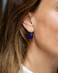 Gold drop earrings with a navy enamel teardrop design