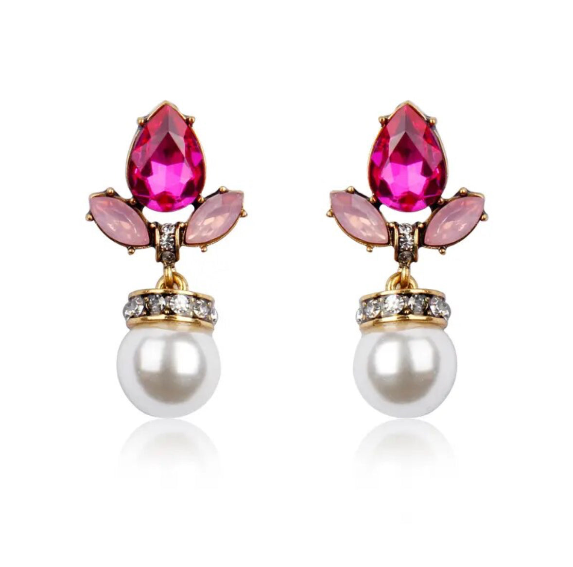 A pair of gold-colored earrings with pink crystal accents and faux pearl drops.