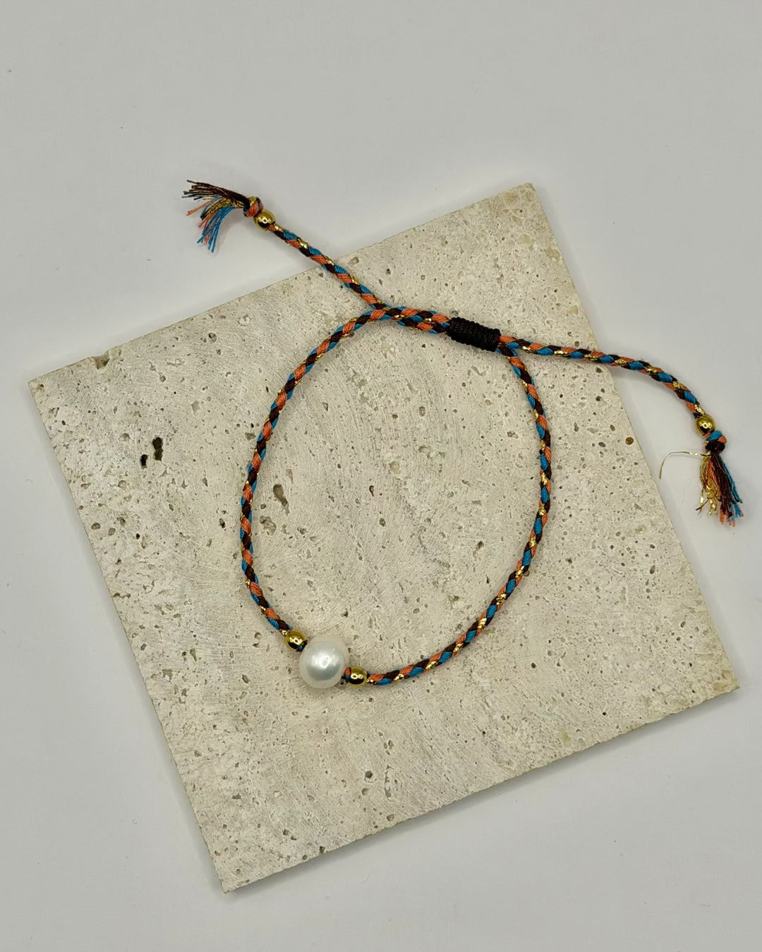 Close-up detail of the Freshwater Pearl Cord Bracelet showing pearl and cord craftsmanship