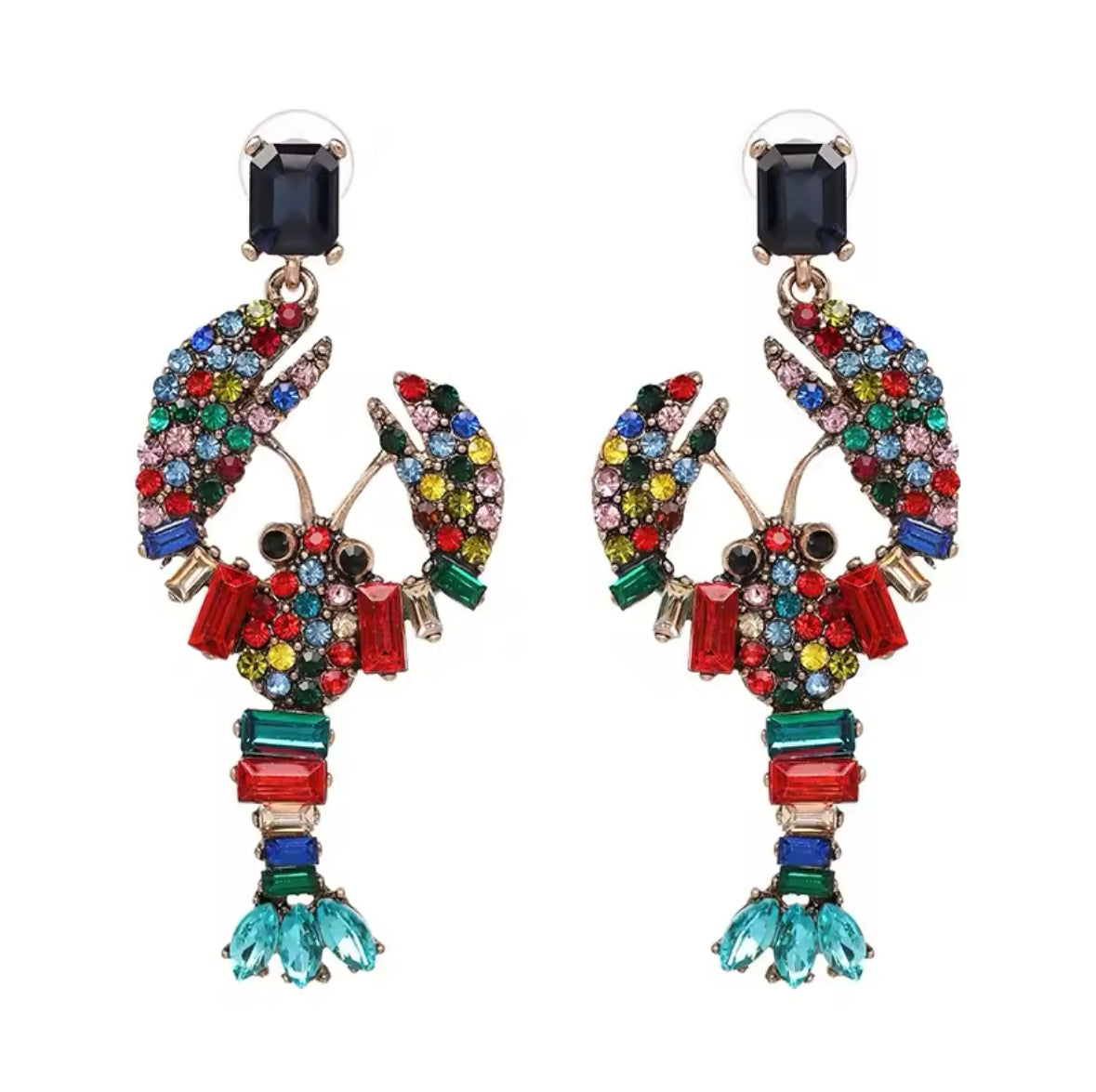 Colourful lobster statement earrings with multicolour crystals worn by woman in red dress at outdoor lunch