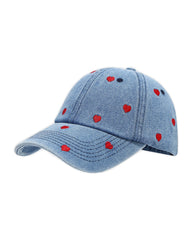 Mid-wash denim baseball cap embroidered with small red hearts, front view on a white background.