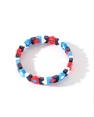 Colorful bracelet with red, blue, and black beads on a white background