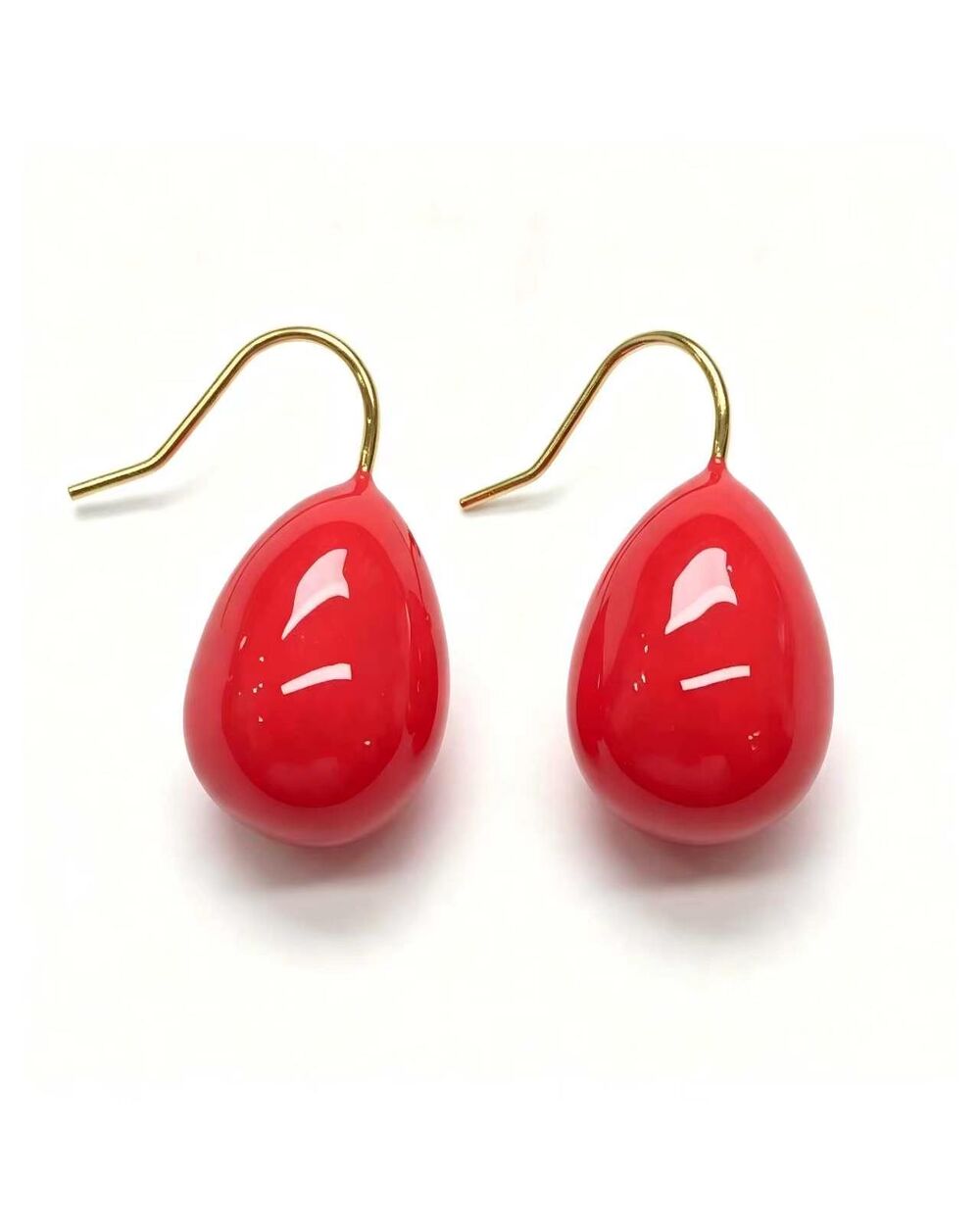 Gold drop earrings with a coral enamel teardrop design
