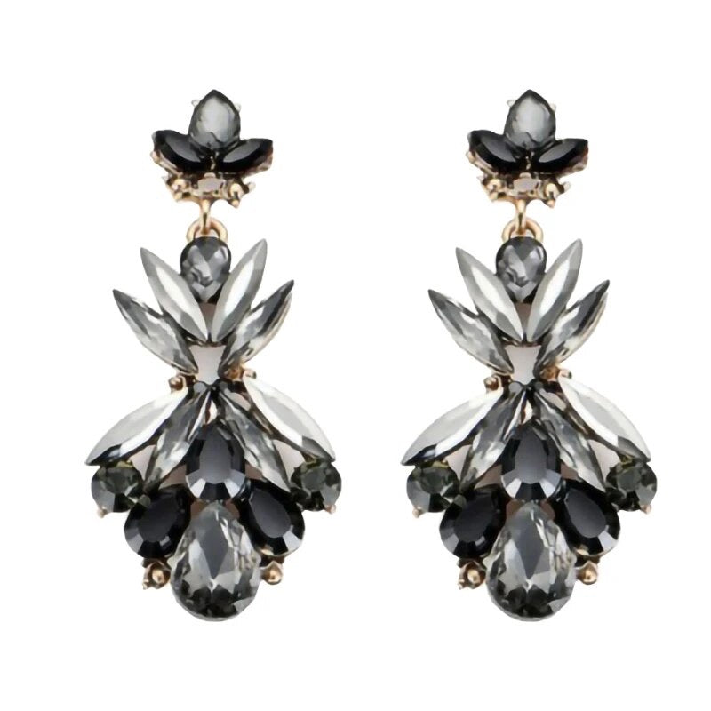 A pair of dangle earrings featuring black and grey crystals arranged in a chandelier style.