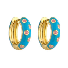 Blue and gold enamel hoop earrings with pink flower pattern on white background