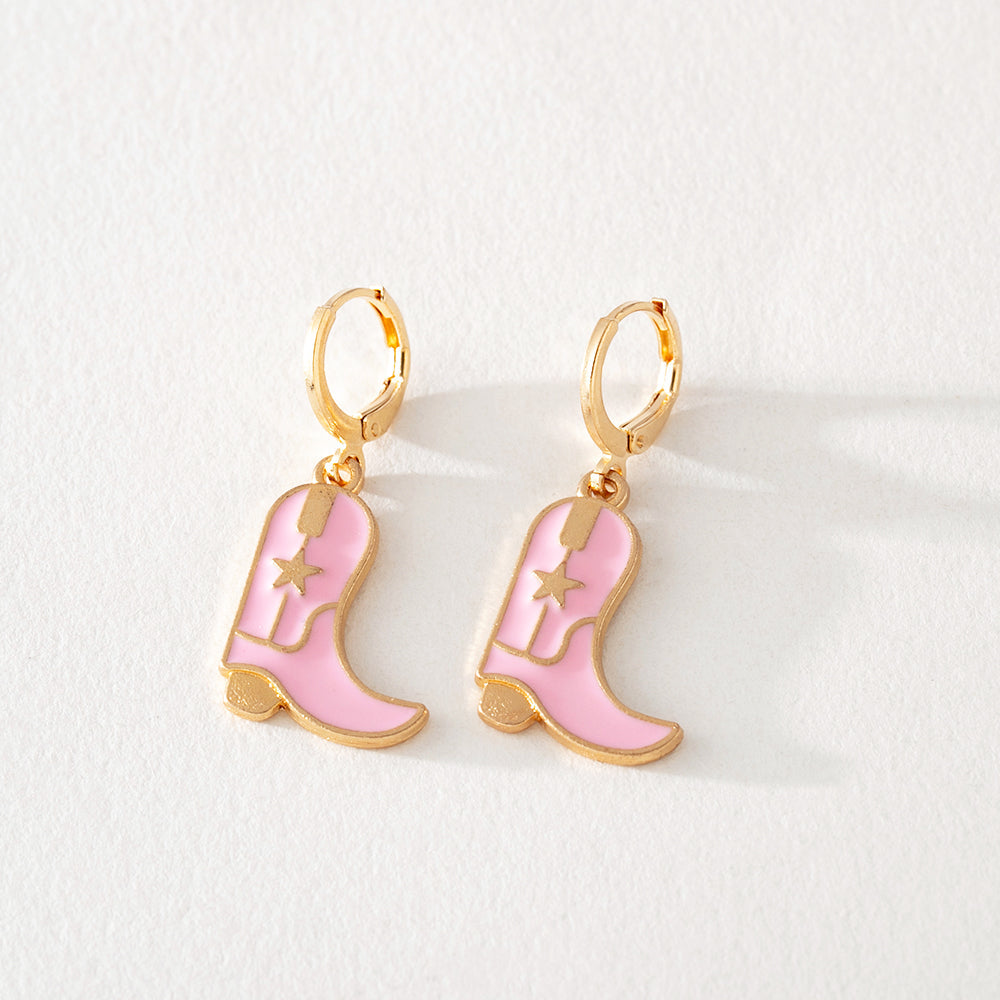 Pink enamel cowboy boot dangle earrings with gold hoop and star detail on white background