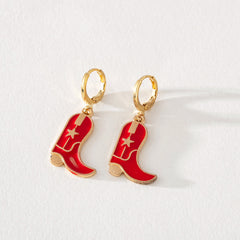 Red enamel cowboy boot dangle earrings with gold hoop and star detail on white background