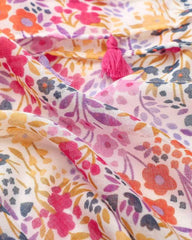 Close-up of multicolour floral print on lightweight scarf fabric with tassel