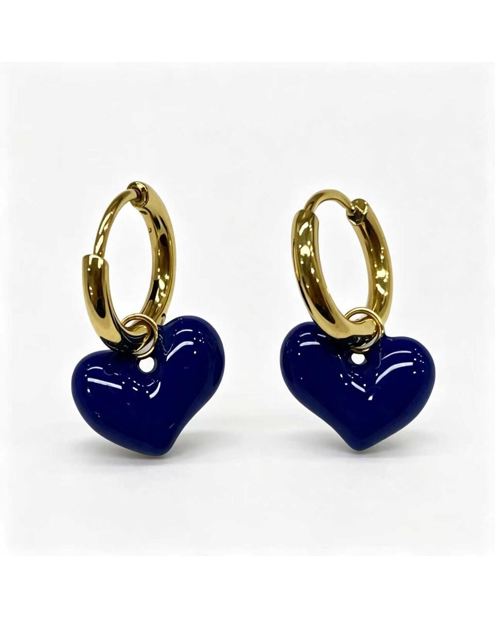 Gold hoop earrings with a navy enamel heart charm dangle