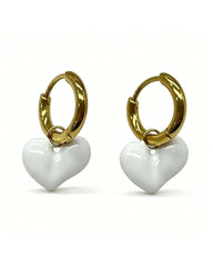 Gold hoop earrings with a white enamel heart charm dangle