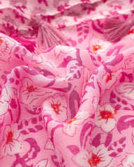 Close-up of pink and magenta floral print on lightweight scarf fabric with tassel